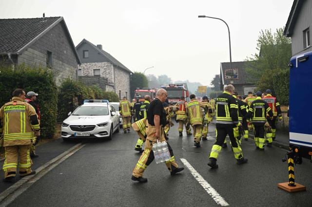 Firefighters and members of the Technical Relief Agency (THW) prepare their operations in Kalterherberg on August 17, 2026 as Belgium's wildfire in High Fens nature reserve threatens german close-by area. The German town of Monschau, on the border with Belgium, ordered the immediate evacuation of a neighborhood on August 16, 2026 evening due to the massive fire ravaging a Belgian forest and approaching Germany. (Photo by INA FASSBENDER / AFP)