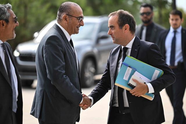 France's Prime Minister Sebastien Lecornu greets France's Interior Minister Laurent Nunez (L) as he arrives for a meeting with officials at Technowest in Merignac, on the outskirts of Bordeaux, south-western France on August 17, 2026 following the giant wildfire. About 200 people in the French village of Le Porge, where 183 homes were destroyed in a giant wildfire last month, jeered France's Prime Minister as he arrived for a visit to the devastated western Gironde region on August 17, 2026. (Photo by Christophe ARCHAMBAULT / POOL / AFP)