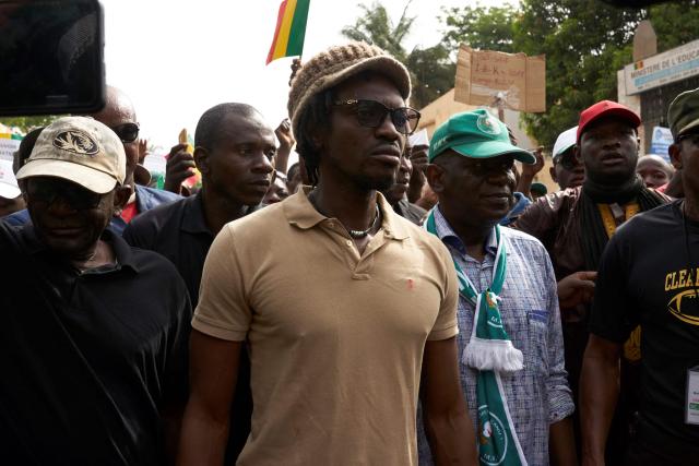(FILES) Malian activist Ras Bath takes part in a demonstration to call for transparency in the upcoming presidential elections in Mali, on June 8, 2018 in Bamako. A Malian court sentenced on Monday a prominent journalist and an influencer, who had both criticised the ruling junta, to seven years in jail, an AFP journalist saw. 
Television and radio commentator Mohamed Youssouf Bathily -- alias Ras Bath -- was convicted by the court in Bamako of criminal conspiracy and discrediting the state, alongside Rokia Doumbia, a noted campaigner known online as "Rose, the cost of living". (Photo by Michele CATTANI / AFP)