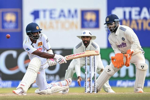Sri Lanka's Prabath Jayasuriya (L) misses to play a shot as India's Rishabh Pant (R) and Devdutt Padikkal watch during the third day of the first Test cricket match between Sri Lanka and India at the Galle International Stadium in Galle on August 17, 2026. (Photo by Ishara S. KODIKARA / AFP)