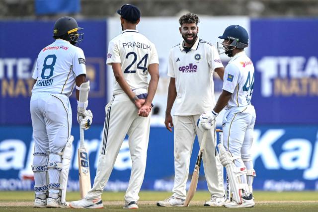 India's Mohammed Siraj (2R) speaks with Sri Lanka's Sonal Dinusha (R) during a break on the third day of the first Test cricket match between Sri Lanka and India at the Galle International Stadium in Galle on August 17, 2026. (Photo by Ishara S. KODIKARA / AFP)