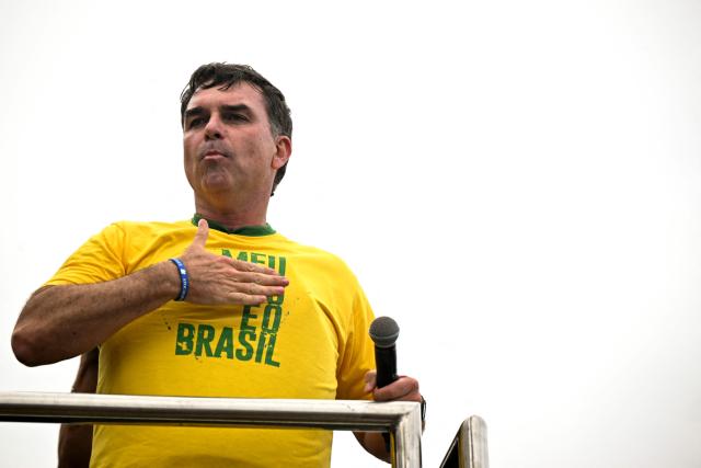 Brazil’s right-wing presidential candidate and senator Flavio Bolsonaro gestures to supporters during a campaign rally at Copacabana Beach in Rio de Janeiro, Brazil, on August 16, 2026. Brazilians will go to the polls next October 4 once again deeply polarized and under the shadow of US President Donald Trump, who has backed conservative candidates in recent elections in Latin America. (Photo by MAURO PIMENTEL / AFP)
