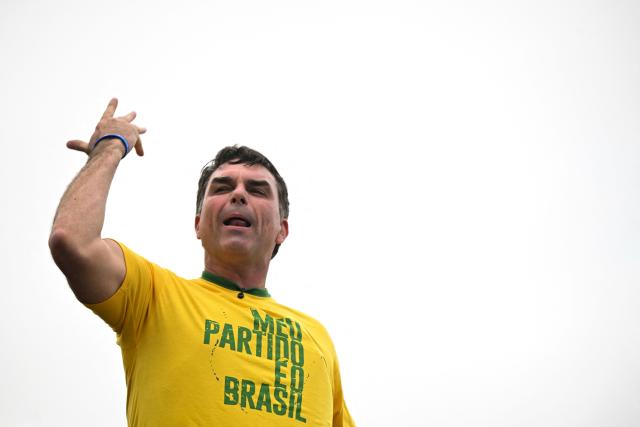 Brazil’s right-wing presidential candidate and senator Flavio Bolsonaro gestures to supporters during a campaign rally at Copacabana Beach in Rio de Janeiro, Brazil, on August 16, 2026. Brazilians will go to the polls next October 4 once again deeply polarized and under the shadow of US President Donald Trump, who has backed conservative candidates in recent elections in Latin America. (Photo by MAURO PIMENTEL / AFP)