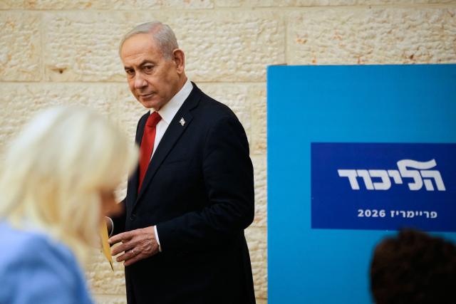 Israeli Prime Minister Benjamin Netanyahu casts his ballot at his party Likud's main polling station during primary elections ahead of Israels general election in October in Jerusalem on August 17, 2026. The Likud, the historic party of the Israeli right and the political base of Prime Minister Benjamin Netanyahu, held primaries on August 17 to determine its slate of candidates for the general election on October 27. Likud is projected to win around 22-23 of the 120 seats in the Knesset, Israel's parliament, according to the latest polls -- a dramatic drop from the 32 seats it won in the 2022 election. (Photo by Ohad Zwigenberg / POOL / AFP)