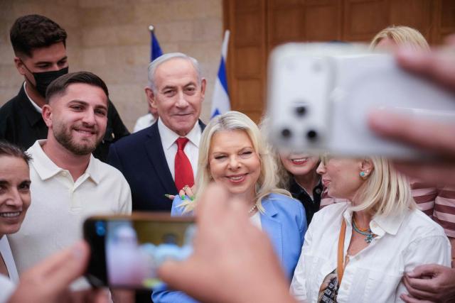 Israeli Prime Minister Benjamin Netanyahu, (C), and his wife, Sara, (C-R) arrive to cast their ballot at his party Likud's main polling station during primary elections ahead of Israels general election in October in Jerusalem on August 17, 2026. The Likud, the historic party of the Israeli right and the political base of Prime Minister Benjamin Netanyahu, held primaries on August 17 to determine its slate of candidates for the general election on October 27. Likud is projected to win around 22-23 of the 120 seats in the Knesset, Israel's parliament, according to the latest polls -- a dramatic drop from the 32 seats it won in the 2022 election. (Photo by Ohad Zwigenberg / POOL / AFP)