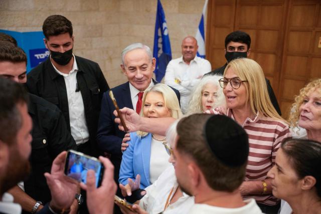 Israeli Prime Minister Benjamin Netanyahu, (C), and his wife, Sara, (C-R) arrive to cast their ballot at his party Likud's main polling station during primary elections ahead of Israels general election in October in Jerusalem on August 17, 2026. The Likud, the historic party of the Israeli right and the political base of Prime Minister Benjamin Netanyahu, held primaries on August 17 to determine its slate of candidates for the general election on October 27. Likud is projected to win around 22-23 of the 120 seats in the Knesset, Israel's parliament, according to the latest polls -- a dramatic drop from the 32 seats it won in the 2022 election. (Photo by Ohad Zwigenberg / POOL / AFP)
