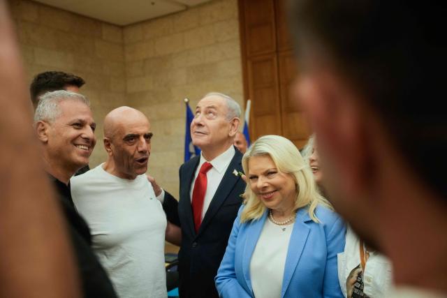 Israeli Prime Minister Benjamin Netanyahu, (C), and his wife, Sara, (C-R) arrive to cast their ballot at his party Likud's main polling station during primary elections ahead of Israels general election in October in Jerusalem on August 17, 2026. The Likud, the historic party of the Israeli right and the political base of Prime Minister Benjamin Netanyahu, held primaries on August 17 to determine its slate of candidates for the general election on October 27. Likud is projected to win around 22-23 of the 120 seats in the Knesset, Israel's parliament, according to the latest polls -- a dramatic drop from the 32 seats it won in the 2022 election. (Photo by Ohad Zwigenberg / POOL / AFP)