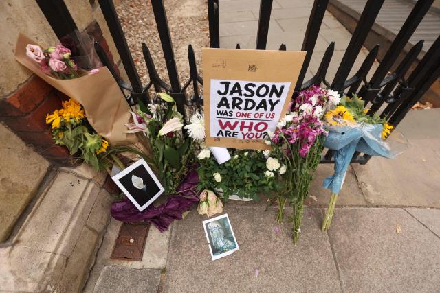 Floral tributes are seen beside the entrance to Jesus College, where the late Cambridge professor Jason Arday was a fellow in the University of Cambridge in Cambridge, eastern England on August 17, 2026, following his death at age 41 on August 14. Arday, the ex-Cambridge professor found dead amid a growing furore over claims of academic plagiarism and personal life embellishments, rose from humble roots in Britain to be hailed as an academic superstar. (Photo by Chris Radburn / AFP)