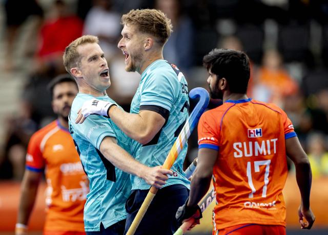 England's Stuart Rushmere (L) and England's Nicholas Bandurak (R) celebrate England's first goal during the 2026 FIH Men's Hockey World Cup group stage match between India and England at the Wagener Stadium in Amstelveen, western Netherlands, on August 17, 2026. (Photo by Koen van Weel / ANP / AFP) / Netherlands OUT