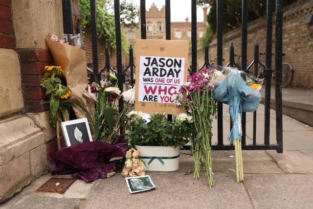 Floral tributes are seen beside the entrance to Jesus College, where the late Cambridge professor Jason Arday was a fellow in the University of Cambridge in Cambridge, eastern England on August 17, 2026, following his death at age 41 on August 14. Arday, the ex-Cambridge professor found dead amid a growing furore over claims of academic plagiarism and personal life embellishments, rose from humble roots in Britain to be hailed as an academic superstar. (Photo by Chris Radburn / AFP)