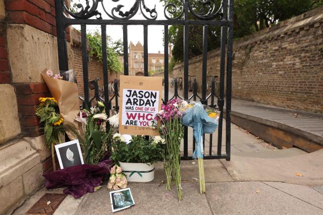 Floral tributes are seen beside the entrance to Jesus College, where the late Cambridge professor Jason Arday was a fellow in the University of Cambridge in Cambridge, eastern England on August 17, 2026, following his death at age 41 on August 14. Arday, the ex-Cambridge professor found dead amid a growing furore over claims of academic plagiarism and personal life embellishments, rose from humble roots in Britain to be hailed as an academic superstar. (Photo by Chris Radburn / AFP)