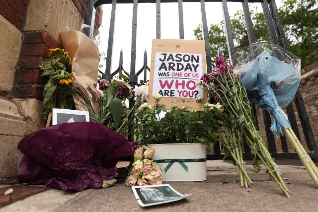 Floral tributes are seen beside the entrance to Jesus College, where the late Cambridge professor Jason Arday was a fellow in the University of Cambridge in Cambridge, eastern England on August 17, 2026, following his death at age 41 on August 14. Arday, the ex-Cambridge professor found dead amid a growing furore over claims of academic plagiarism and personal life embellishments, rose from humble roots in Britain to be hailed as an academic superstar. (Photo by Chris Radburn / AFP)
