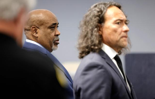 Duane Davis (L) stands with his attorney Michael Sanft during the opening statements of his murder trial, related to the 1996 killing of rapper Tupac Shakur, at Clark County District Court in the Regional Justice Center in Las Vegas, Nevada, on August 17, 2026. The trial of the former gang leader accused of orchestrating the murder of rapper Tupac Shakur began on August 10, 30 years after one of America's most high-profile unresolved killings. The proceedings, expected to last a month, will likely not make clear who fired the shots that killed the California hip-hop legend on the night of September 7, 1996, while he was in Las Vegas to see a Mike Tyson boxing match. (Photo by STEVE MARCUS / POOL / AFP)