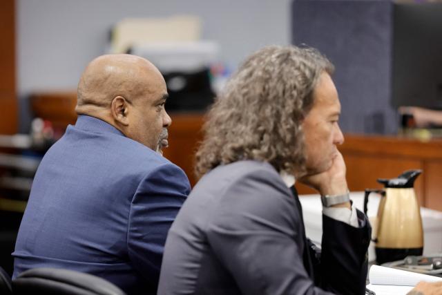 Duane Davis (L) sits with his attorney Michael Sanft during the opening statements of his murder trial, related to the 1996 killing of rapper Tupac Shakur, at Clark County District Court in the Regional Justice Center in Las Vegas, Nevada, on August 17, 2026. The trial of the former gang leader accused of orchestrating the murder of rapper Tupac Shakur began on August 10, 30 years after one of America's most high-profile unresolved killings. The proceedings, expected to last a month, will likely not make clear who fired the shots that killed the California hip-hop legend on the night of September 7, 1996, while he was in Las Vegas to see a Mike Tyson boxing match. (Photo by STEVE MARCUS / POOL / AFP)