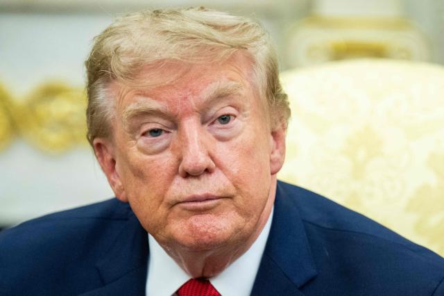 US President Donald Trump looks on as as he meets with lifeguard Ryder Williams in the Oval Office of the White House in Washington, DC, on August 17, 2026. The 16-year-old Williams rescued 10-year-old Nathaniel Rai in rough surf at Seabright Beach last month in Santa Cruz, California. (Photo by Jim WATSON / AFP)