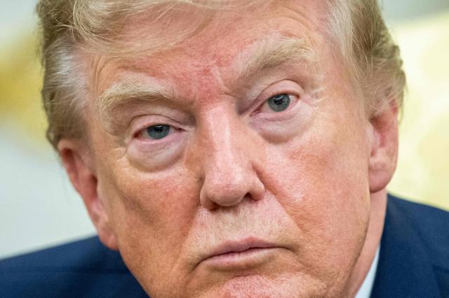 US President Donald Trump looks on as as he meets with lifeguard Ryder Williams in the Oval Office of the White House in Washington, DC, on August 17, 2026. The 16-year-old Williams rescued 10-year-old Nathaniel Rai in rough surf at Seabright Beach last month in Santa Cruz, California. (Photo by Jim WATSON / AFP)