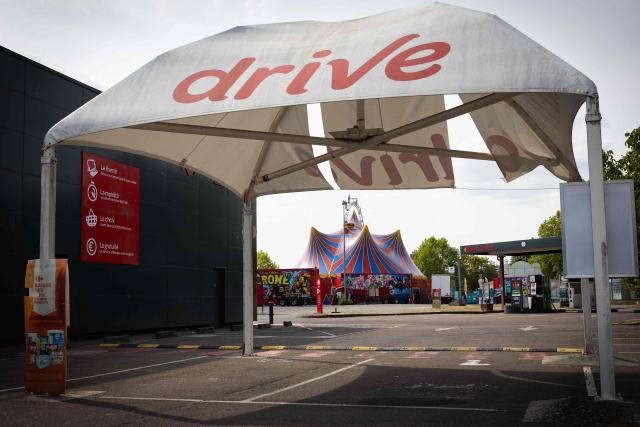 This photograph shows the Crone Circus Big Top set up in the parking lot of a Carrefour Market in Pont-Audemer, on August 16, 2026. Traveling circus' have been marked by some recurring tensions regarding unauthorized installations on public or private land. (Photo by JOEL SAGET / AFP)