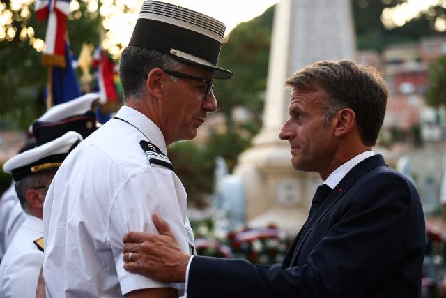 French President Emmanuel Macron greets attendees during a ceremony commemorating the 82nd anniversary of the Allied 'Operation Dragoon' landings in Provence and the liberation of the village of Bormes-les-Mimosas during World War II, in Bormes-les-Mimosas, southeastern France, on August 17, 2026. (Photo by Manon Cruz / POOL / AFP)