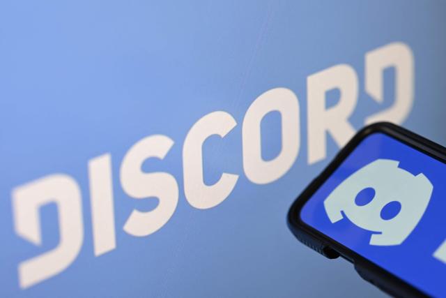 (FILES) This photo illustration shows the logo of the US company Discord displayed on a smartphone and a screen in Rio de Janeiro, Brazil, on August 12, 2026. Popular messaging platform Discord said on August 17, 2026 that it had complied with a Brazilian government order to suspend livestreaming and video calls in the country after a teen girl was allegedly goaded into taking her own life during one such broadcast. (Photo by MAURO PIMENTEL / AFP)