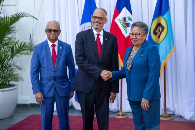 Haiti's Prime Minister Alix Didier Fils-Aime (C) poses with Organization of American States (OAS) Secretary General Albert Ramdin (L) and Caribbean Community (CARICOM)  Secretary General Carla Barnett during their meeting at the National Palace in Port-au-Prince, Haiti, on August 17, 2026. (Photo by Clarens SIFFROY / AFP)