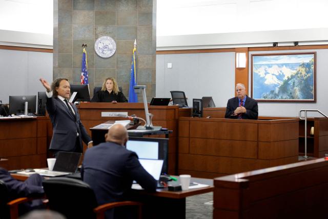 Michael Sanft (L), attorney for Duane Davis, asks a question to Garry Dale, a former Las Vegas Metro Police Department officer, during the Duane Davis murder trial, related to the 1996 killing of rapper Tupac Shakur, at Clark County District Court at the Regional Justice Center in Las Vegas, Nevada, on August 17, 2026. The trial of the former gang leader accused of orchestrating the murder of rapper Tupac Shakur began on August 10, 30 years after one of America's most high-profile unresolved killings. The proceedings, expected to last a month, will likely not make clear who fired the shots that killed the California hip-hop legend on the night of September 7, 1996, while he was in Las Vegas to see a Mike Tyson boxing match. (Photo by STEVE MARCUS / POOL / AFP)