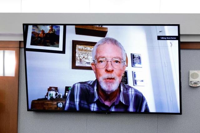 Brent Becker, a retired Las Vegas Metro Police Department homicide detective, testifies by video feed during the Duane Davis murder trial, related to the 1996 killing of rapper Tupac Shakur, at Clark County District Court at the Regional Justice Center in Las Vegas, Nevada, on August 17, 2026. The trial of the former gang leader accused of orchestrating the murder of rapper Tupac Shakur began on August 10, 30 years after one of America's most high-profile unresolved killings. The proceedings, expected to last a month, will likely not make clear who fired the shots that killed the California hip-hop legend on the night of September 7, 1996, while he was in Las Vegas to see a Mike Tyson boxing match. (Photo by STEVE MARCUS / POOL / AFP)
