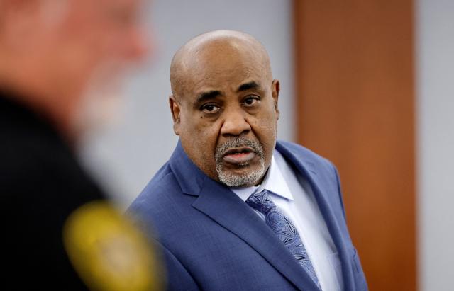 Duane Davis enters the courtroom after a break in his murder trial, related to the 1996 killing of rapper Tupac Shakur, at Clark County District Court at the Regional Justice Center in Las Vegas, Nevada, on August 17, 2026. The trial of the former gang leader accused of orchestrating the murder of rapper Tupac Shakur began on August 10, 30 years after one of America's most high-profile unresolved killings. The proceedings, expected to last a month, will likely not make clear who fired the shots that killed the California hip-hop legend on the night of September 7, 1996, while he was in Las Vegas to see a Mike Tyson boxing match. (Photo by STEVE MARCUS / POOL / AFP)