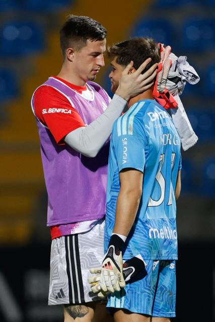 Casa Pia's Portuguese goalkeeper Andre Gomes (R) is consoled by Benfica's Ukrainian goalkeeper #01 Anatolii Trubin after their Portuguese League football match between Casa Pia AC and SL Benfica at the Municpal Stadium in Rio Maior, north of Lisbon on August 17, 2026. Casa Pia lost their home match 0-7 with Benfica's Greek forward #14 Vangelis Pavlidis scoring a hat-trick. (Photo by FILIPE AMORIM / AFP)