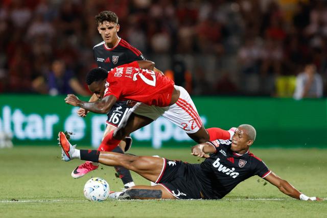 Benfica's Colombian forward #22 Jhon Duran (C) is challenged for the ball by Casa Pia's Angolan defender #03 Kaly (R) during the Portuguese League football match between Casa Pia AC and SL Benfica at the Municpal Stadium in Rio Maior, north of Lisbon on August 17, 2026. 22, 3 (Photo by FILIPE AMORIM / AFP)