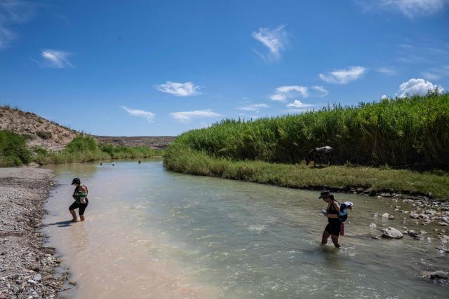 (FILES) Tourists cross the Rio Grande, on the US-Mexico border inside Big Bend National Park, in southern Texas, on August 15, 2026. US President Donald Trump's administration said August 17, 2026 it had paused construction on a $1.7 billion border project at Big Bend National Park in Texas that has faced fierce local opposition across party lines. (Photo by RONALDO SCHEMIDT / AFP)