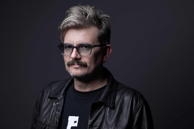 (FILES) French cartoonist known by his pen name Luz, former contributor to the satirical magazine Charlie Hebdo, poses during a photo session in Paris on October 11, 2023. In the summer of 2025, cartoonist Luz spent the night at the Centre Pompidou in Paris, known as Beaubourg, among the ghosts of the artists who once inhabited the museum, now closed for renovation, and those that have haunted him since the attack that decimated Charlie Hebdo, his second family. (Photo by JOEL SAGET / AFP)