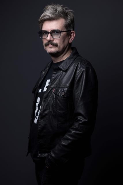 (FILES) French cartoonist known by his pen name Luz, former contributor to the satirical magazine Charlie Hebdo, poses during a photo session in Paris on October 11, 2023. In the summer of 2025, cartoonist Luz spent the night at the Centre Pompidou in Paris, known as Beaubourg, among the ghosts of the artists who once inhabited the museum, now closed for renovation, and those that have haunted him since the attack that decimated Charlie Hebdo, his second family. (Photo by JOEL SAGET / AFP)