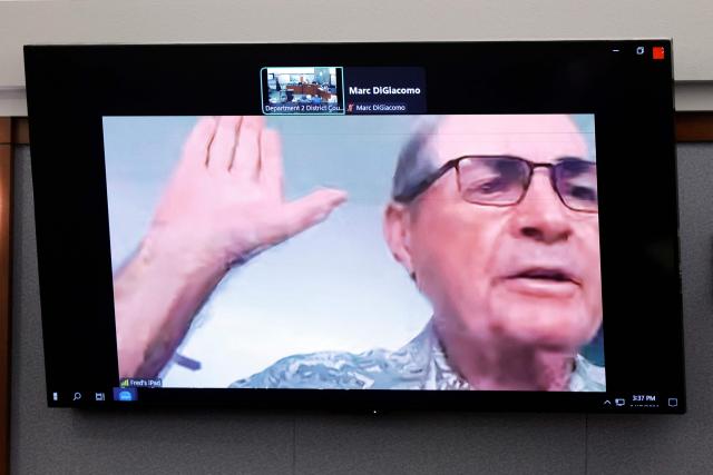 Fred Miller, a retired Los Angeles Police Department homicide detective, is sworn in by video feed during Duane Davis murder trial, related to the 1996 killing of rapper Tupac Shakur, at Clark County District Court at the Regional Justice Center in Las Vegas, Nevada, on August 17, 2026. The trial of the former gang leader accused of orchestrating the murder of rapper Tupac Shakur began on August 10, 30 years after one of America's most high-profile unresolved killings. The proceedings, expected to last a month, will likely not make clear who fired the shots that killed the California hip-hop legend on the night of September 7, 1996, while he was in Las Vegas to see a Mike Tyson boxing match. (Photo by Steve Marcus / POOL / AFP)