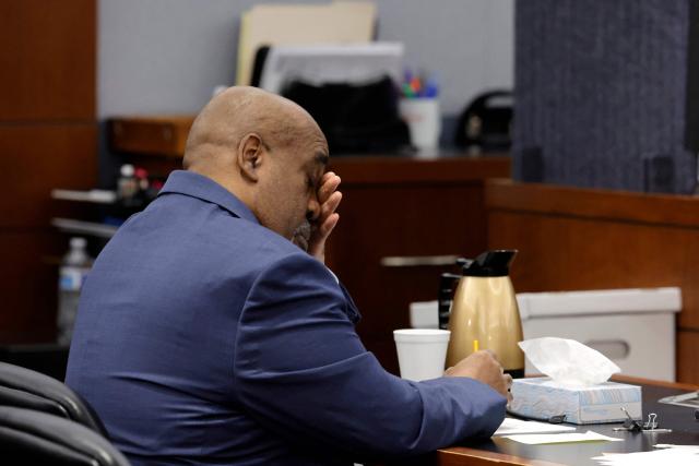 Duane Davis rubs his face during his murder trial, related to the 1996 killing of rapper Tupac Shakur, at Clark County District Court Regional Justice Center, in Las Vegas, Nevada, on August 17, 2026. The trial of the former gang leader accused of orchestrating the murder of rapper Tupac Shakur began on August 10, 30 years after one of America's most high-profile unresolved killings. The proceedings, expected to last a month, will likely not make clear who fired the shots that killed the California hip-hop legend on the night of September 7, 1996, while he was in Las Vegas to see a Mike Tyson boxing match. (Photo by Steve Marcus / POOL / AFP)