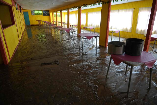 The fishermen's cove is covered in mud after a mudslide following heavy rains in Puerto Viejo, Caldera commune, Atacama region, Chile on August 17, 2026. (Photo by Patricio BANDA / AFP)