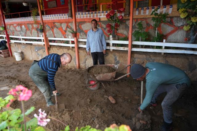 Locals remove mud from their property after a mudslide following heavy rains in Puerto Viejo, Caldera commune, Atacama region, Chile on August 17, 2026. (Photo by Patricio BANDA / AFP)