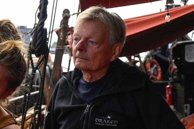 Bjorn Ahlander, captain of the Draken Harald Harfagre (the ship used in the movie the Odyssey) is pictured on board as the ship is docked outside Oslo Opera in the Norwegian capital on August 14, 2026. Ulysses on a Viking ship? Two millennia separate the two worlds. Yet it’s precisely on board such a vessel that Christopher Nolan has the Greek hero sail in “The Odyssey,” a deliberate anachronism in the service of realism. With its tar-soaked ropes, creaking oak deck, and fifty slender spruce oars, the Draken Harald Hеrfagre, the largest modern replica of a Viking ship, has, for the duration of a film shoot, swapped the fantasy of Scandinavian sagas for that of Greek mythology. (Photo by Jonathan KLEIN / AFP)