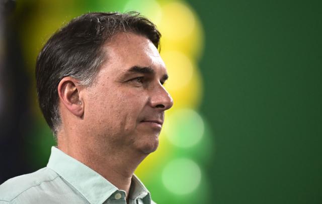 Senator and right-wing presidential candidate Flavio Bolsonaro gestures towards supporters during a rally at Mackenzie Esporte Clube in Belo Horizonte, Brazil on August 17, 2026. Brazilians will go to the polls next October 4 once again deeply polarized and under the shadow of US President Donald Trump, who has backed conservative candidates in recent elections in Latin America. (Photo by Gledston Tavares / AFP)
