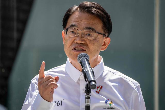 Governor of Aichi Prefecture Hideaki Omura speaks during the torch lighting ceremony for the 2026 Asian Games, outside the National Stadium in Tokyo on August 18, 2026. About 15,000 competitors and officials are expected at the event, which takes place in Nagoya and the wider Aichi area from September 19 to October 4. (Photo by Yuichi YAMAZAKI / AFP)