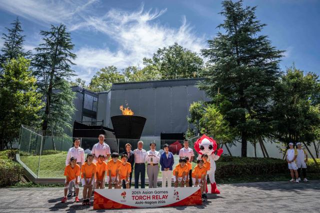 (Back L-R) Mayor of Nagoya Ichiro Hirosawa, former Japanese hammer throw athlete Koji Murofushi, President of the Japan Olympic Committee Seiko Hashimoto, Vice President of the Olympic Council of Asia Tsunekazu Takeda, Governor of Aichi Prefecture Hideaki Omura, Governor of Tokyo Yuriko Koike and Japanese sprinter Yoshihide Kiryu pose during the torch lighting ceremony for the 2026 Asian Games, outside the National Stadium in Tokyo on August 18, 2026. About 15,000 competitors and officials are expected at the event, which takes place in Nagoya and the wider Aichi area from September 19 to October 4. (Photo by Yuichi YAMAZAKI / AFP)