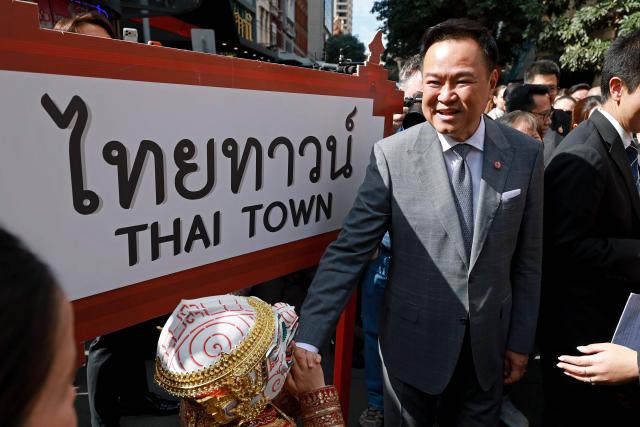 Thailand's Prime Minister Anutin Charnvirakul (C) reacts as he meets locals during a visit to Thaitown in Sydney on August 18, 2026. The Thai Prime Minister is on a three-day official visit to Australia. (Photo by DAVID GRAY / AFP)