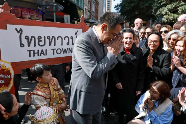Thailand's Prime Minister Anutin Charnvirakul (C) reacts as he meets locals during a visit Thaitown in Sydney on August 18, 2026. The Thai Prime Minister is on a three-day official visit to Australia. (Photo by DAVID GRAY / AFP)