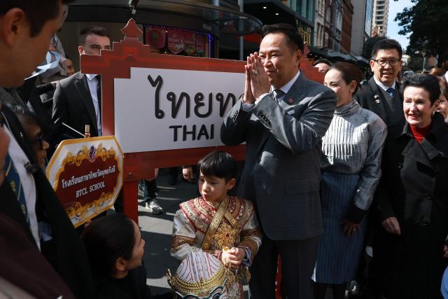 Thailand's Prime Minister Anutin Charnvirakul (C) reacts as he meets locals during a visit to Thaitown in Sydney on August 18, 2026. The Thai Prime Minister is on a three-day official visit to Australia. (Photo by DAVID GRAY / AFP)