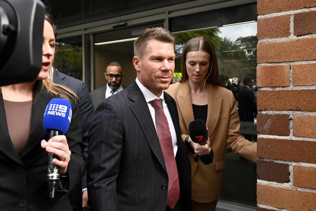 Australia's former cricketer David Warner (C) leaves Waverley Local Court in Sydney on August 18, 2026, after being fined and ordered to use a vehicle breathalyser lock following his admission to a drink-driving offence. Warner, a world-renowned former opening batsman for Australia, pleaded guilty last month to a "middle range" drink-driving offence. (Photo by Saeed KHAN / AFP)