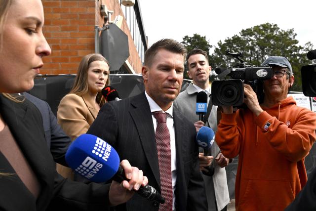 Australia's former cricketer David Warner (C) leaves Waverley Local Court in Sydney on August 18, 2026, after being fined and ordered to use a vehicle breathalyser lock following his admission to a drink-driving offence. Warner, a world-renowned former opening batsman for Australia, pleaded guilty last month to a "middle range" drink-driving offence. (Photo by Saeed KHAN / AFP)