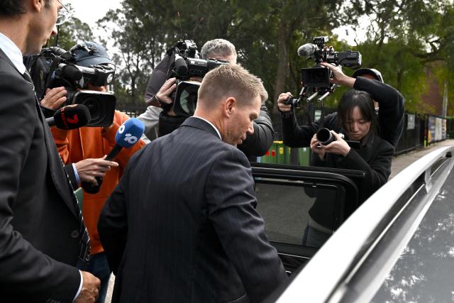 Australia's former cricketer David Warner (C) leaves Waverley Local Court in Sydney on August 18, 2026, after being fined and ordered to use a vehicle breathalyser lock following his admission to a drink-driving offence. Warner, a world-renowned former opening batsman for Australia, pleaded guilty last month to a "middle range" drink-driving offence. (Photo by Saeed KHAN / AFP)