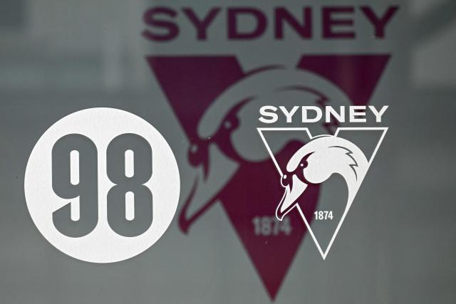 The Sydney Swans logo is seen on the door of the Australian Rules side's headquarters building in Sydney on August 18, 2026. Top Australian Rules side the Sydney Swans said it was "extremely shocked and disappointed" on August 17 after several unidentified players were involved in an "alleged incident" in Melbourne. (Photo by Saeed KHAN / AFP)