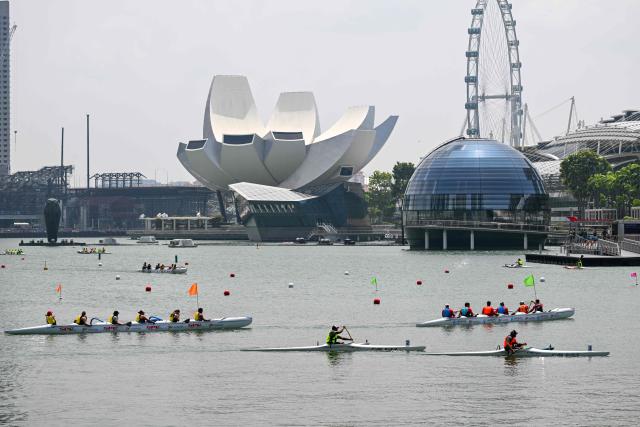 Rowers compete in an outrigger canoe race during the Singapore Va'a World Sprints Championships 2026 in Marina Bay in Singapore on August 18, 2026. (Photo by Roslan RAHMAN / AFP)