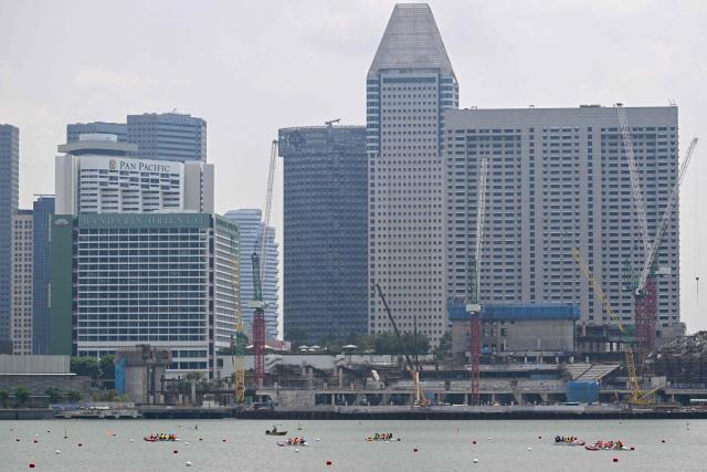 Rowers compete in an outrigger canoe race during the Singapore Va'a World Sprints Championships 2026 in Marina Bay in Singapore on August 18, 2026. (Photo by Roslan RAHMAN / AFP)
