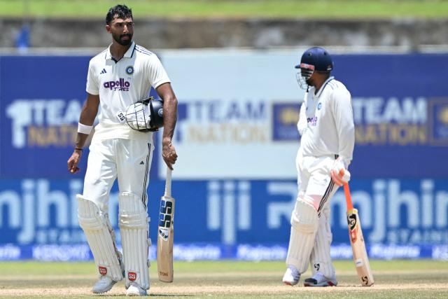 India's Devdutt Padikkal (L) walks back to the pavilion after his dismissal during the fourth day of the first Test cricket match between Sri Lanka and India at the Galle International Stadium in Galle on August 18, 2026. (Photo by Ishara S. KODIKARA / AFP)